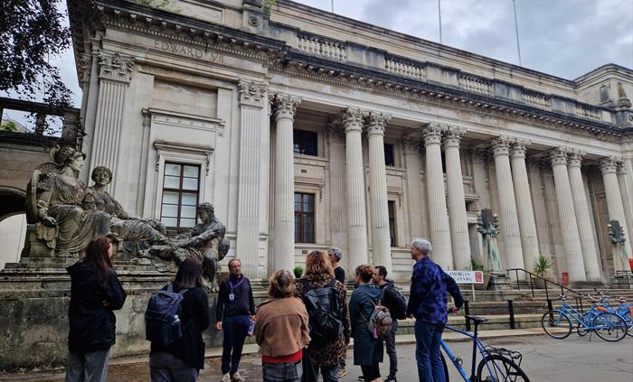 Group listening to tour guide outside Glamorgan